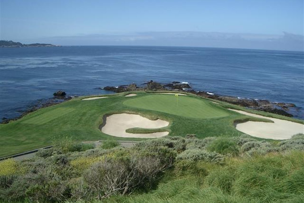 The seventh green and sand bunkers at Pebble Beach Golf Links beside the Pacific Ocean, photographed in 2005.