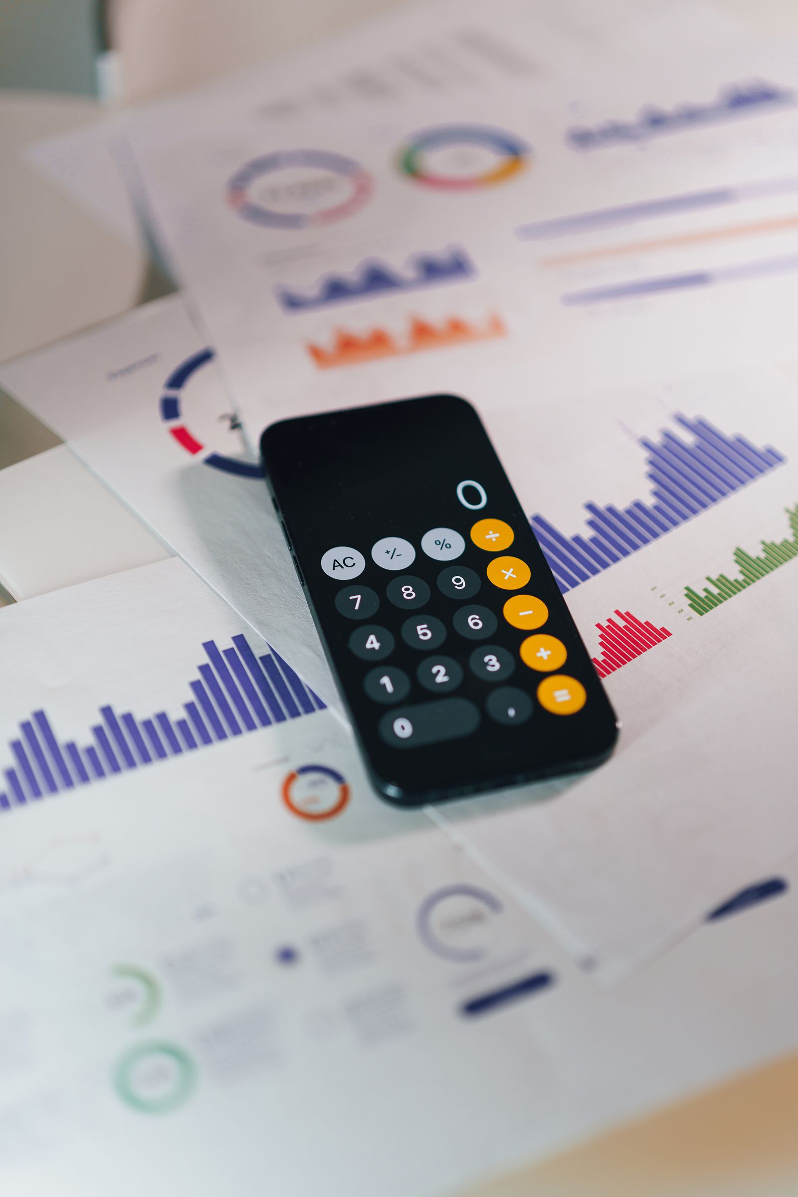 Calculator on printed financial charts illustrating withdrawal timing and costs